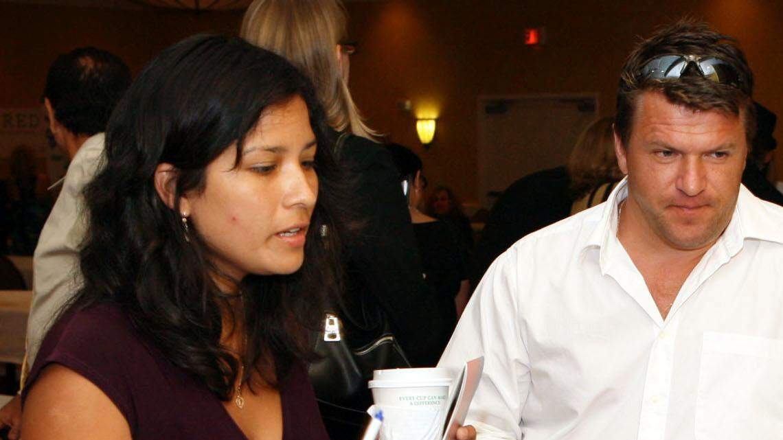 FILE--This Career Solutions Expo job fair took place in Fort Lauderdale in 2009. Here, Erika Vivas (left) and Victor Trifanov (right), both of West Palm Beach, talk to Jose Gonzalez (sitting), a Training Services Coordinator from Everest University.

