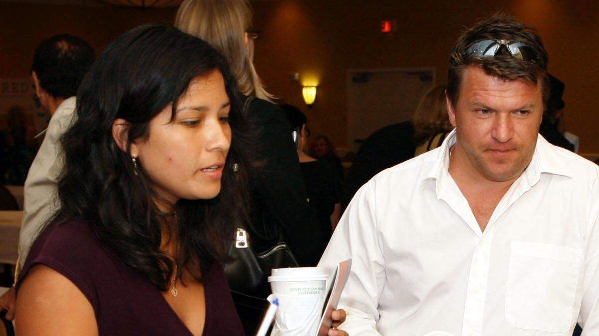 FILE--This Career Solutions Expo job fair took place in Fort Lauderdale in 2009. Here, Erika Vivas (left) and Victor Trifanov (right), both of West Palm Beach, talk to Jose Gonzalez (sitting), a Training Services Coordinator from Everest University.

