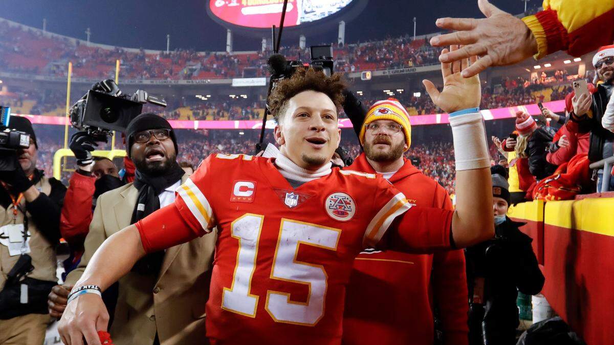 Kansas City Chiefs quarterback Patrick Mahomes (15) celebrates with fans as he walks off the field after an NFL divisional round playoff football game against the Buffalo Bills, Sunday, Jan. 23, 2022, in Kansas City, Mo. The Chiefs won 42-36 in overtime. (AP Photo/Colin E. Braley)