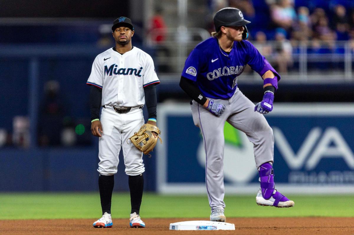Miami Marlins shortstop Xavier Edwards (9) looks on as Colorado Rockies base runner Hunter Goodman (15) reacts to hitting a double during the fourth inning of an MLB game at loanDepot park on Tuesday, June 3, 2025, in Miami, Fla.