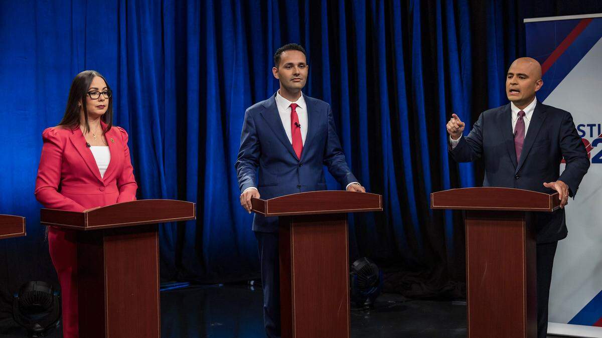 Hialeah Interim Mayor Jackie Garcia-Roves and former Councilman Bryan Calvo listen as Councilman Jesus Tundidor talks during a mayoral-election debate at Univision 23 ahead of the Nov. 4 elections on Wednesday.