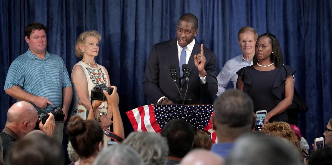 Tallahassee Mayor Andrew Gillum, the Democratic candidate for governor, speaks to a gathering of Democrats at a rally held at The International Union of Painters & Allied Trades Local 1010 in Orlando, Florida, on Aug. 31, 2018. On stage with Gillum are his wife, R. Jai Gillum, right, and Sen. Bill Nelson and his family.