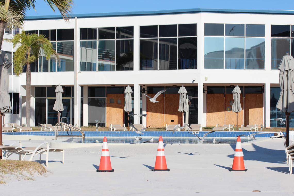 First floors windows are boarded up and birds have taken residence in a pool at a closed resort on St. Pete Beach on Nov. 13, more than a year after hurricanes hit the area in 2024.