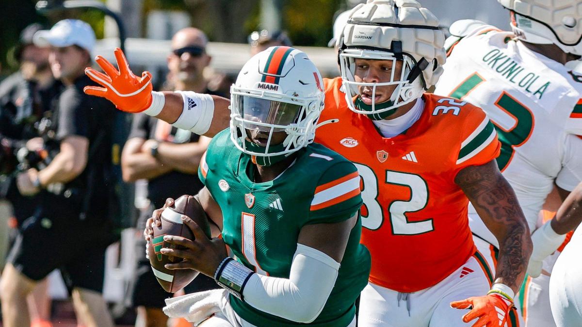 Miami Hurricanes quarterback Cam Ward (1) scrambles out of the pocket as Miami Hurricanes linebacker Raul Aguirre Jr. (32) gives chase during the Canes spring football game at the University of Miami’s Cobb Stadium in Coral Gables, Florida on Saturday, April 13, 2024.