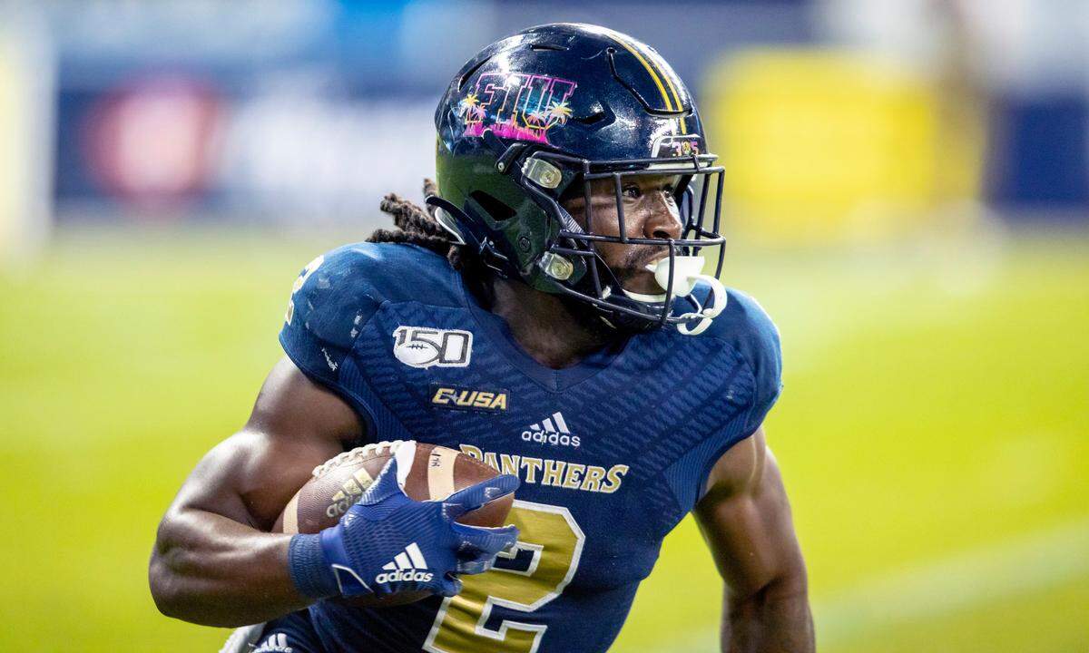 Florida International University runnning back Anthony Jones (2) runs the ball during the fourth quarter of a football game against University of Miami at Marlins Park in Miami, Florida on Saturday, November 23, 2019.