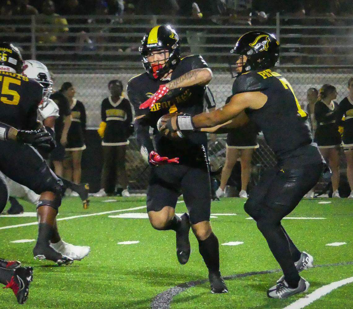American Heritage had home field advantage in their playoff game against Cardinal Gibbons Friday, Nov. 25th. Here, QB Blake Murphy hands off to WR Brandon Inniss in the first action.