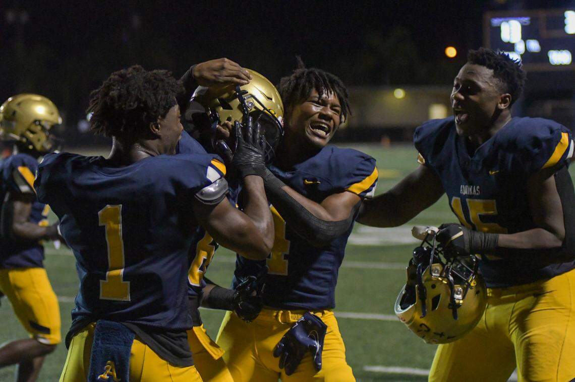 St. Thomas Aquinas players celebrate with wide receiver Jaylen Bonelli after his touchdown catch in a Region 3-3M game against Coconut Creek on Friday, Nov. 11, 2022, at St. Thomas Aquinas High School in Fort Lauderdale, Florida.