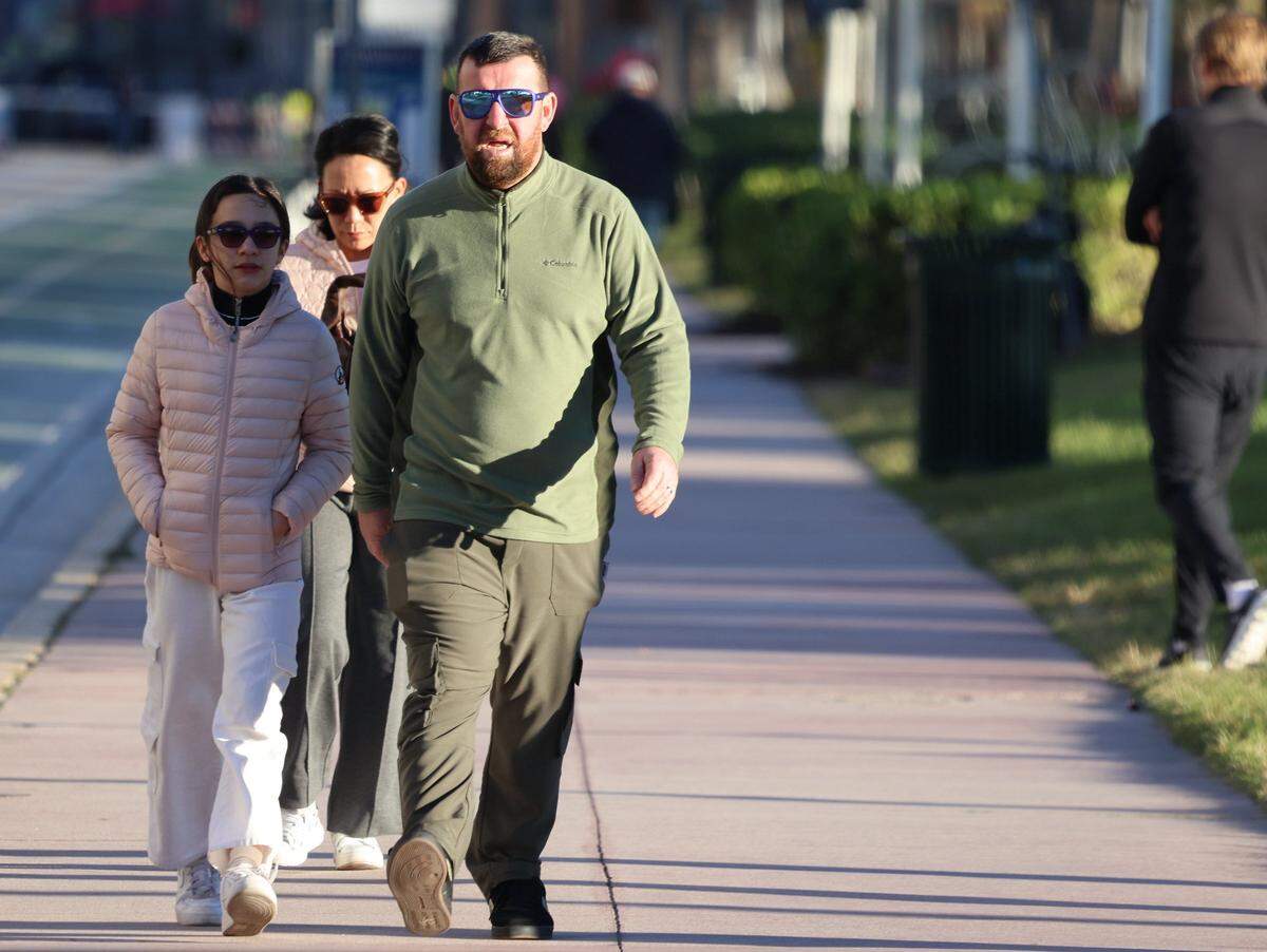 Cool temperatures brought coats, jackets, hoodies, sweater, and other cold-weather gear to bear as morning strollers dressed for the change in weather. An arctic blast moved into South Florida late Tuesday, bringing a sharp overnight temperature drop. Visitors and residents alike promenade in hoodies, sweaters, coats, and other cold-weather gear on Ocean Drive as breezy north winds made it feel colder through New Year's Eve and New Year's Day. Morning lows were in the upper 40s to low 50s, with daytime highs near the low 70s on Wednesday, December 31, 2025, in Miami Beach, Florida.