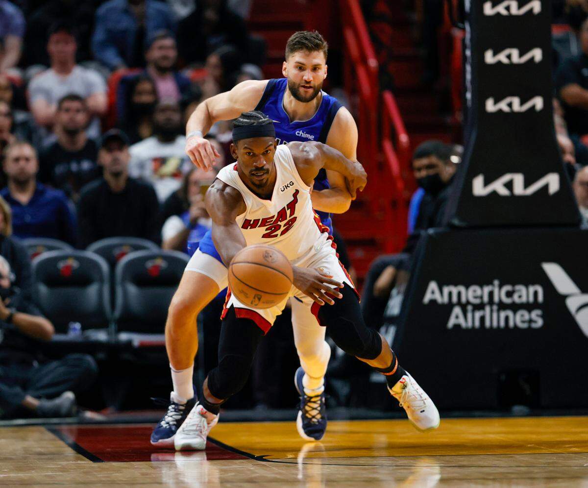 Miami Heat forward Jimmy Butler (22) battle for a loose ball against Dallas Mavericks forward Maxi Kleber (42) during the fourth quarter of their NBA basketball game at the FTX Arena on Tuesday, February 15, 2022 in Miami, Fl.