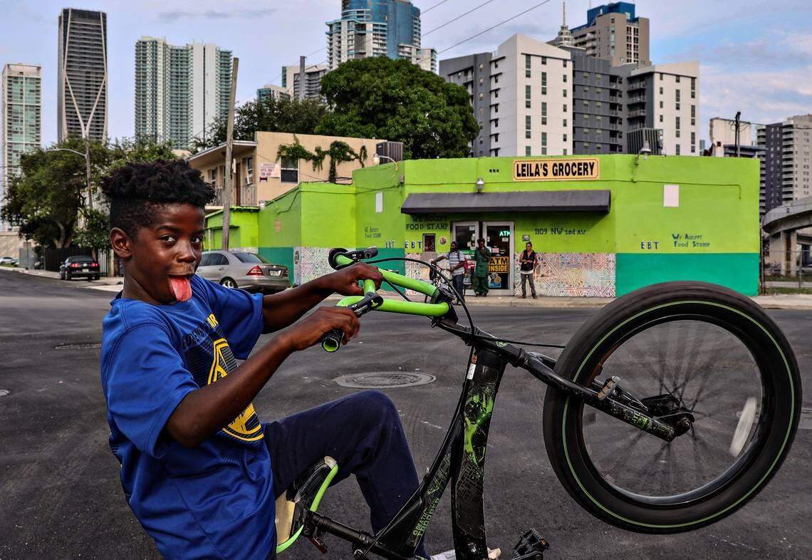 Zion Cooper, 10, rides his bike on May 14, 2019, at the corner of Northwest First Place and Northwest 11th Street in Overtown, one of the poorest neighborhoods within City of Miami limits.
