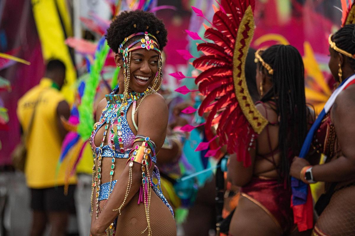 A performer poses for photos during Miami Carnival at the Miami-Dade County Fair Expo in Miami, Florida on Sunday, October 9, 2022.