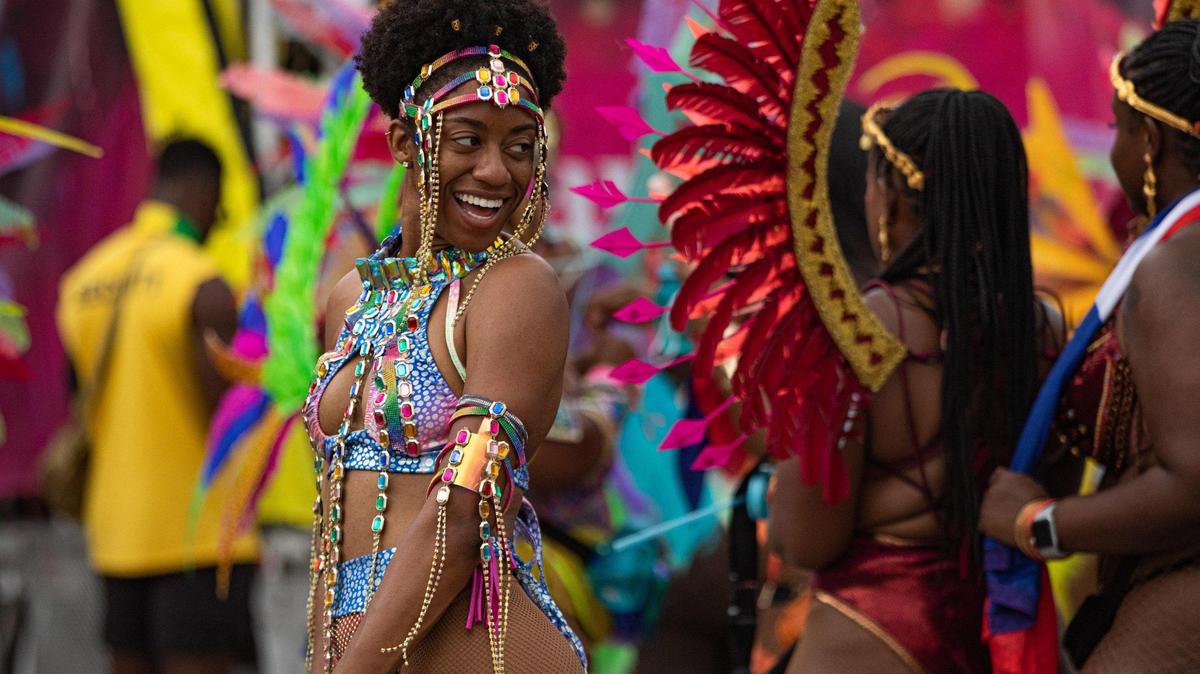 A performer poses for photos during Miami Carnival at the Miami-Dade County Fair Expo in Miami, Florida on Sunday, October 9, 2022.