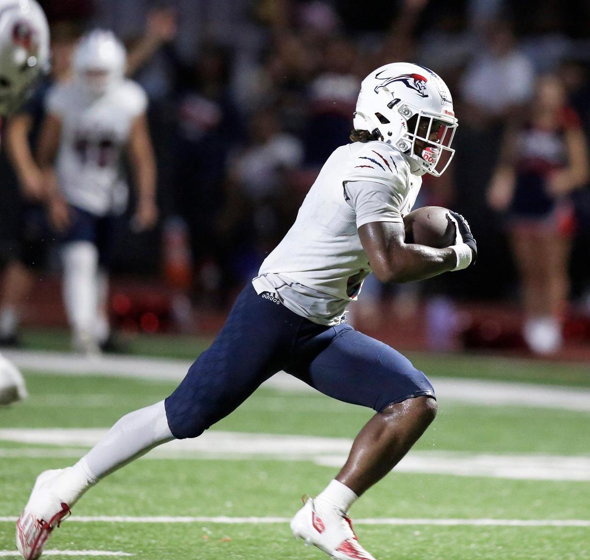Chaminade-Madonna Lions Jaquri Lewis (5) runs for a touchdown against Cardinal Gibbons Chiefs during the football game on Friday, September 1, 2023 at Cardinal Gibbons HS in Fort Lauderdale. Andrew Uloza / for Miami Herald