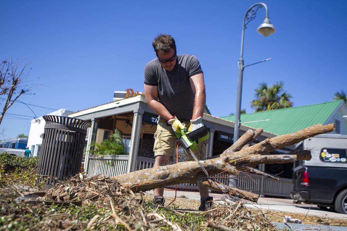 Matt Peevy, 31, cuts down a fallen tree near his real estate brokerage in Port Saint Joe, Florida eight days after Hurricane Michael devastated the area leaving hundreds of thousands without shelter, power and food.