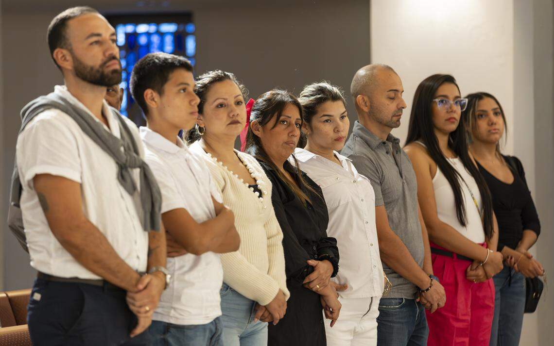 From left to right: Leandro Giraldo, Juan Pablo Susa, Mayerly Susa, Yiralit Vanegas, Laura, Miguel Pereira, Melissa Quiroz and Sara Trujillo listen to a pastor speak during a vigil at Christ Lutheran Church on Saturday, Aug. 9, 2025, in Oakland Park, Fla. The vigil brought together immigrant families and others supporting loved ones in migrant detention centers, such as Alligator Alcatraz, across the state and country. Laura, who is undocumented, has a 13-year-old son and was recently diagnosed with terminal cancer, watched two months ago as her husband, Luis, was detained by ICE and taken to a detention center in Louisiana.