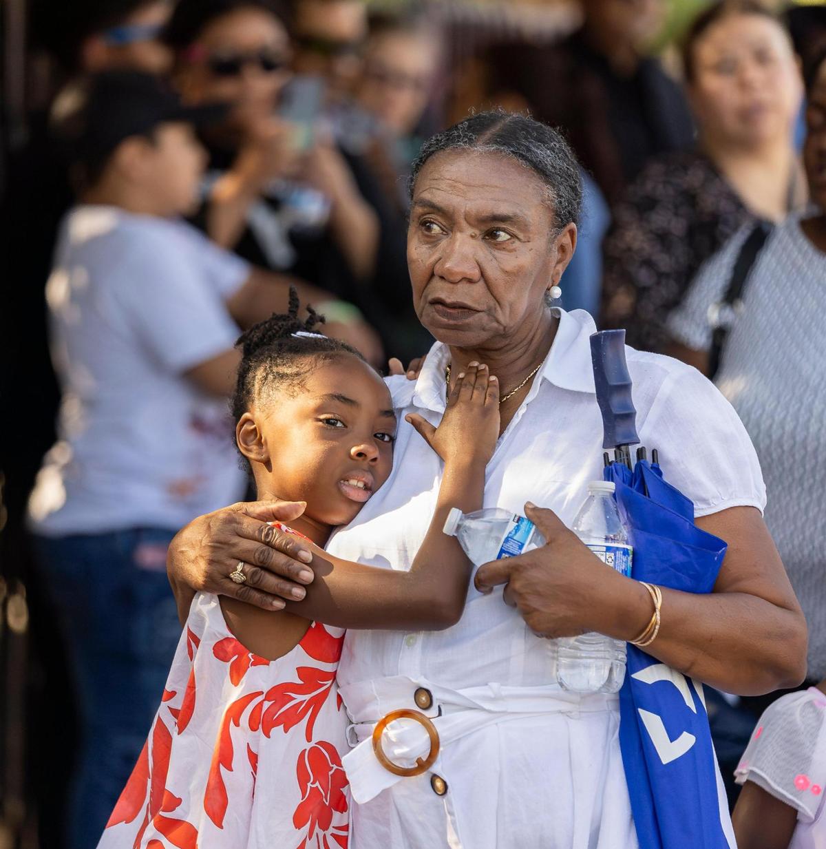 Jenner Philizaire and her granddaughter, Emma Philizaire, 6, attend the Living Stations of the Cross procession near the Cathedral of St. Mary on Friday, April 18, 2025, in Miami, Fla.