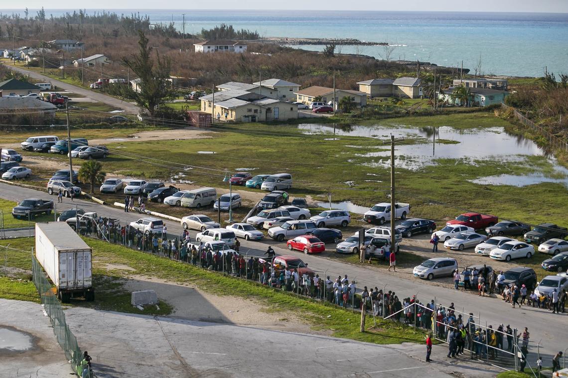More than 100 people wait outside of the Freeport Cruise Port in Grand Bahama on Friday, Sept. 6, 2019. Some Bahamians await the arrival of family members, while others are trying to depart from the island.