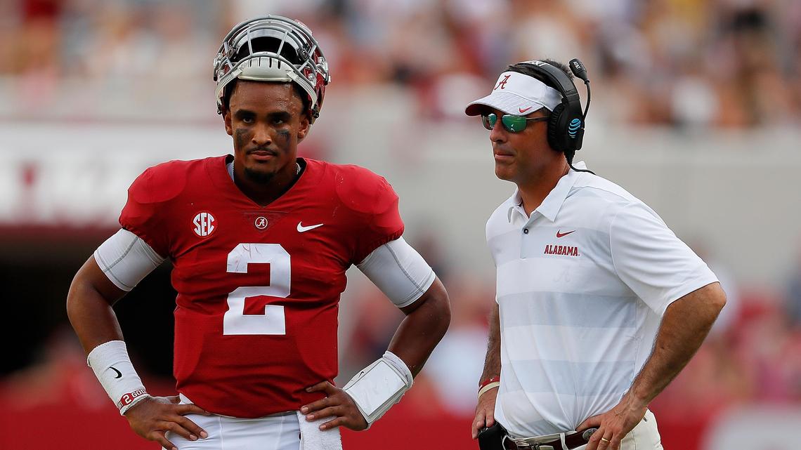 Jalen Hurts of the Alabama Crimson Tide converses with quarterbacks coach Dan Enos during the game against the Arkansas State Red Wolves at Bryant-Denny Stadium on Sept. 8, 2018, in Tuscaloosa, Alabama.