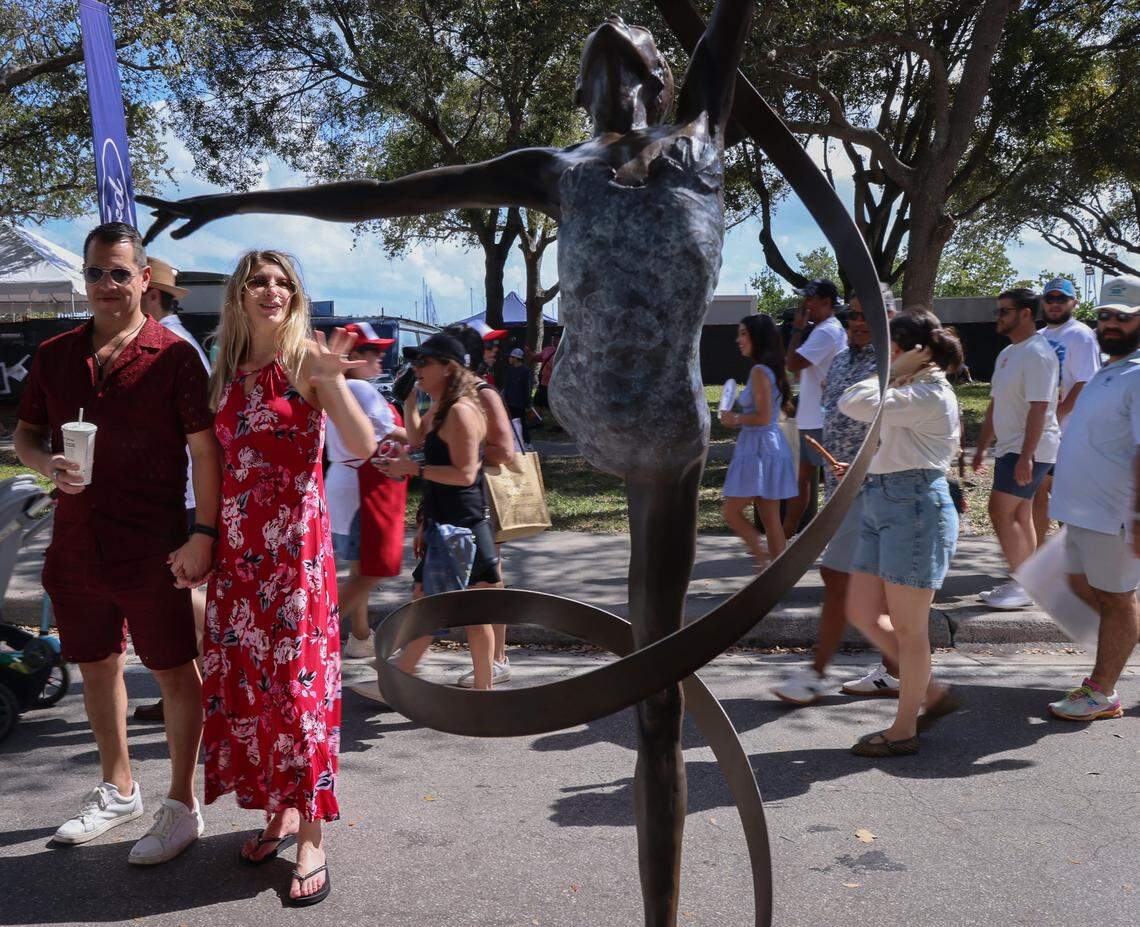 A couple pause as they admire Lori Betz's “Ribbon Dancer” at the Coconut Grove Art Festival.Centered at Regatta Park in Dinner Key Marina overlooking Biscayne Bay, the festival spanned McFarlane Road, Pan American Drive and South Bayshore Drive, where the works of more than 275 artists were on display on Sunday, February 15, 2026, in Miami, Florida. 