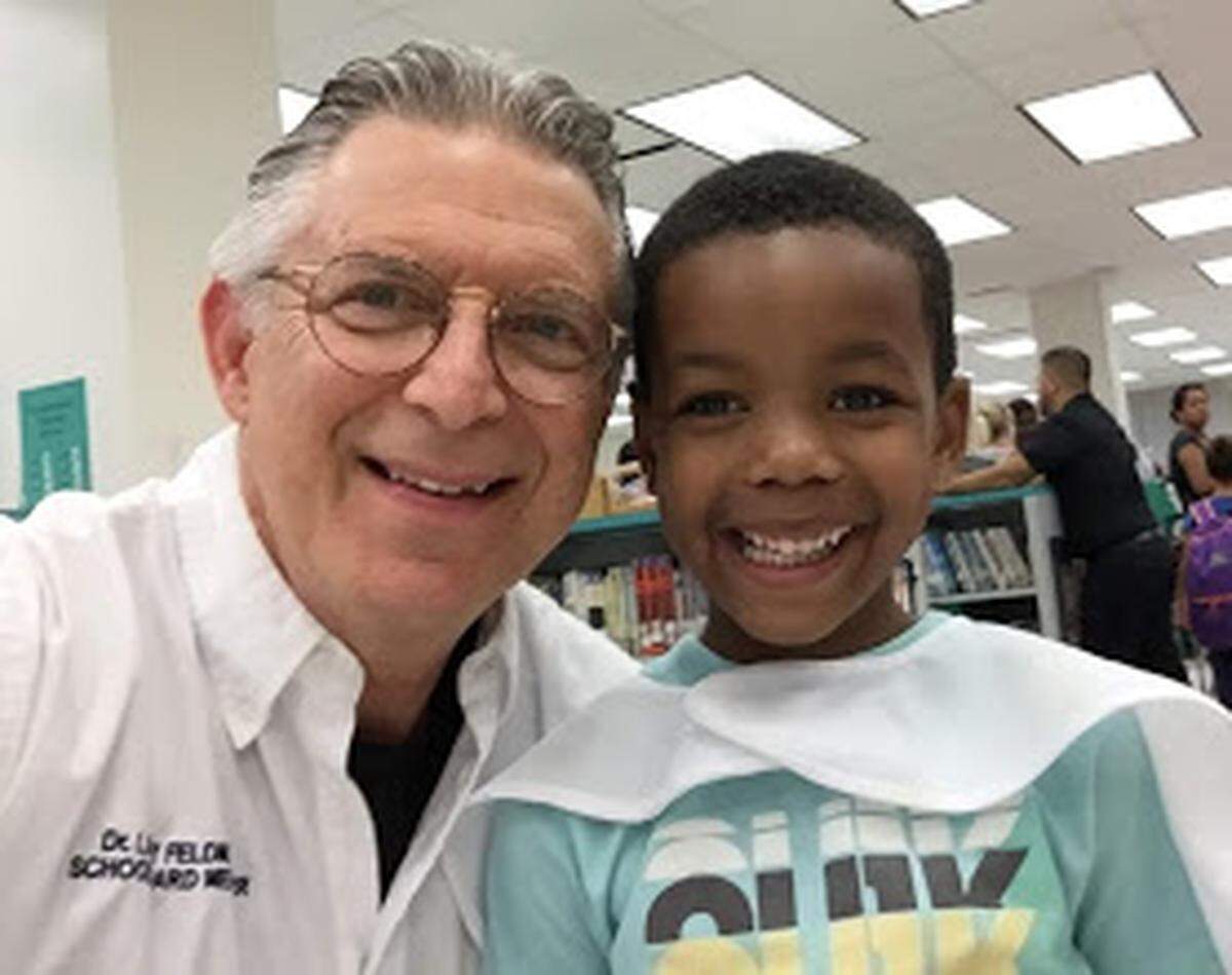 Miami-Dade County School Board Member Larry Feldman, left, with a student from District 9 during his annual Back-to-School Backpack and Supply Giveaway Event. It was at Campbell Drive K-8 Center, Avocado Elementary and Robert Russa Moton Elementary schools.