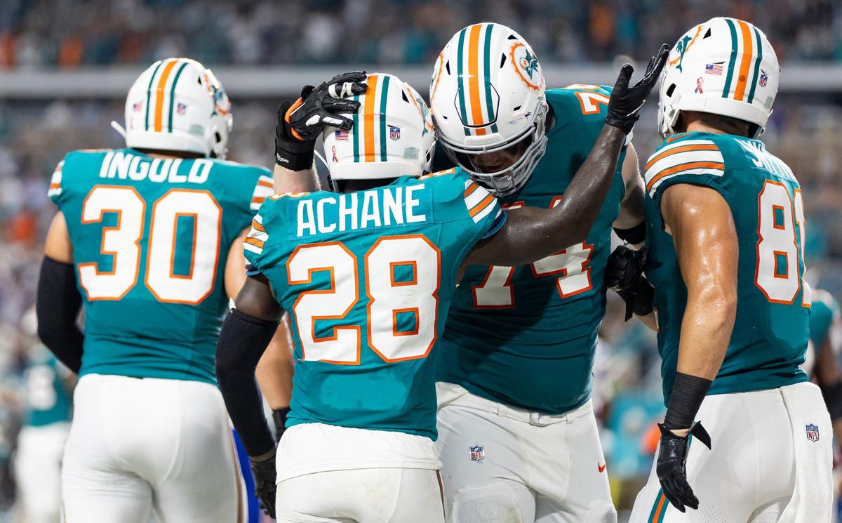 Miami Dolphins running back De’Von Achane (28) celebrates with offensive tackle Liam Eichenberg (74) after scoring a touchdown against the Buffalo Bills in the first half of their NFL game at Hard Rock Stadium on Thursday, Sept. 12, 2024, in Miami Gardens, Fla.
