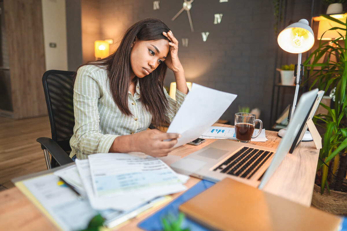 Worried young black women stressing over her financial bills