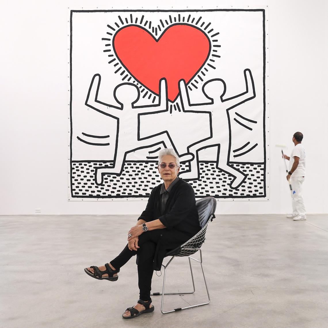Art collector Mera Rubell sits in front of Keith Haring’s “Untitled,” an acrylic on vinyl tarpaulin that she and husband Don acquired in 1982, as their new Rubell Museum in Miami’s Allapattah neighborhood prepares for its opening during Art Basel week.
