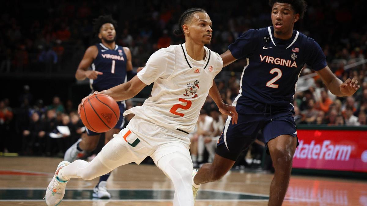 Hurricane’s Isaiah Wong (2) dribbles around Virginia Cavalier’s Reece Beekman (2) during the first half of an NCAA game between the University of Miami Hurricanes and the University of Virginia Cavaliers on Tuesday, Dec. 20, 2022, at the Watsco Center in Coral Gables. The score was 36-26 at the half with the Hurricanes in the lead.
