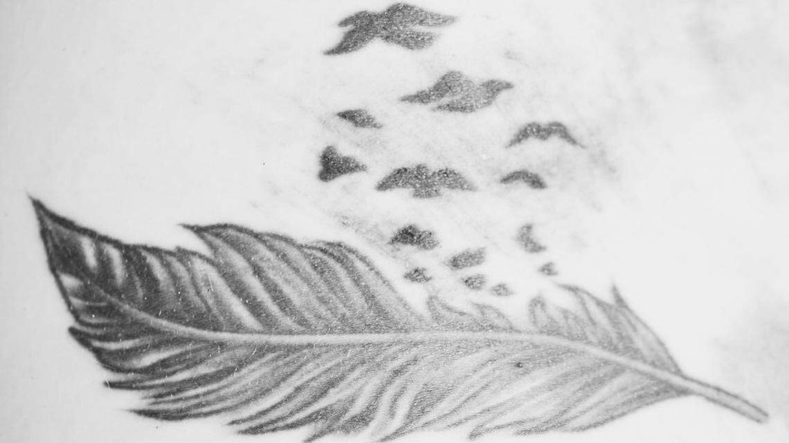 A woman was found dead in the shoulder of a highway in New Hampshire and needs to be identified, state police say. Authorities released a photo of her back tattoo.