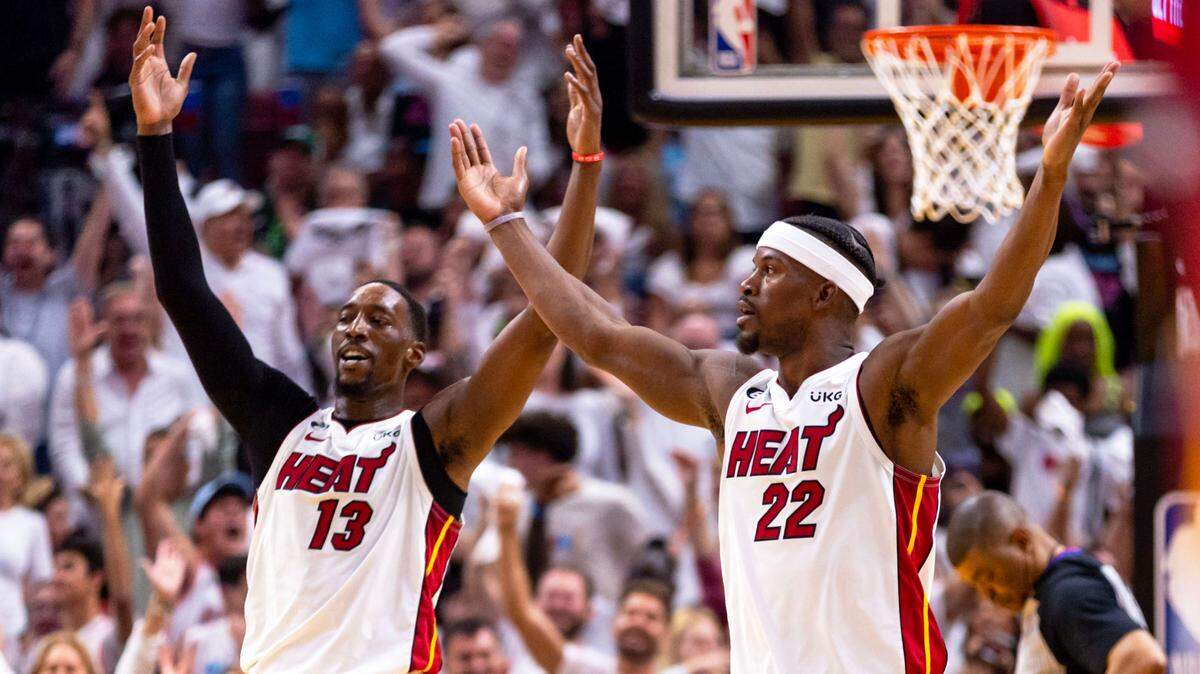 Miami Heat forward Jimmy Butler (22) and center Bam Adebayo (13) react during the second half of Game 3 of the NBA Eastern Conference Finals series against the Boston Celtics at Kaseya Center in Miami, Florida, on May 21, 2023.