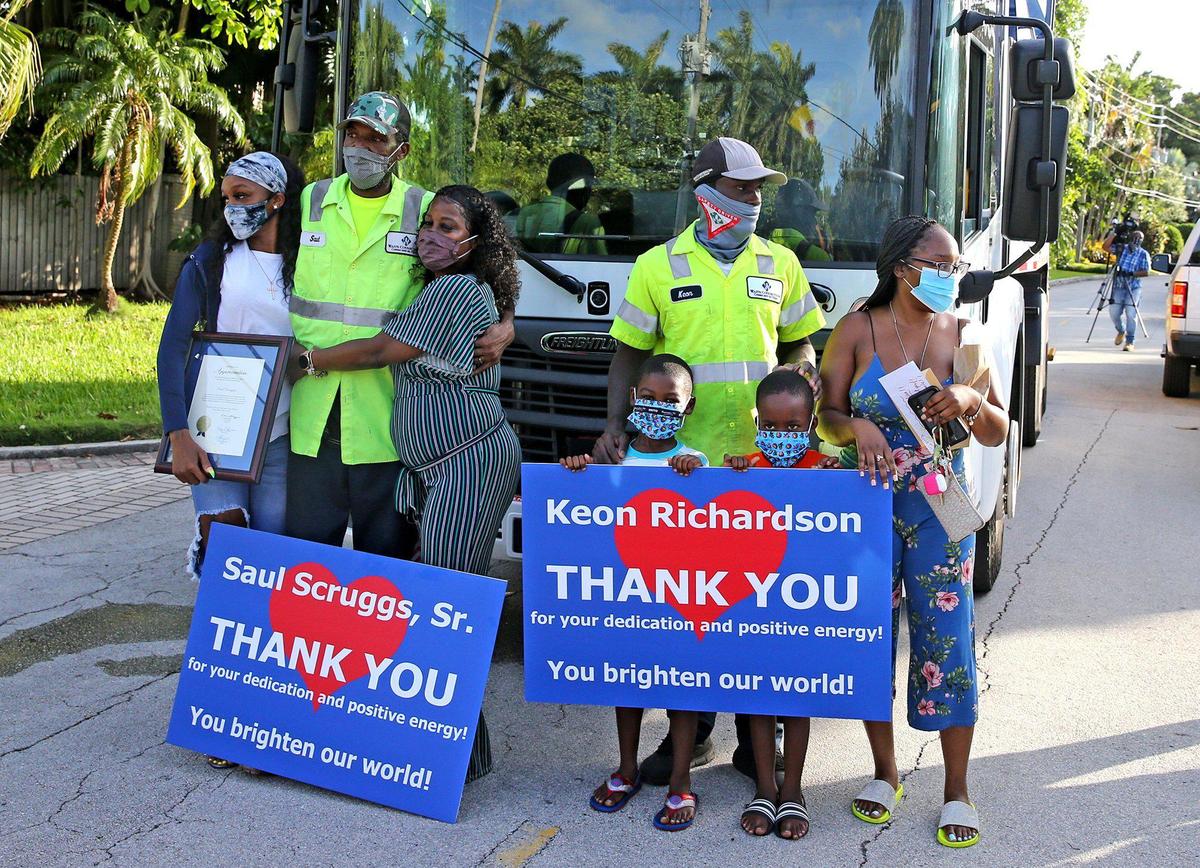 Miami Beach waste haulers, Saul Scruggs and Keon Richardson, at an outdoor celebration at 7:40 a.m. Friday as the neighborhood thanks them for their diligent work and positive attitudes.