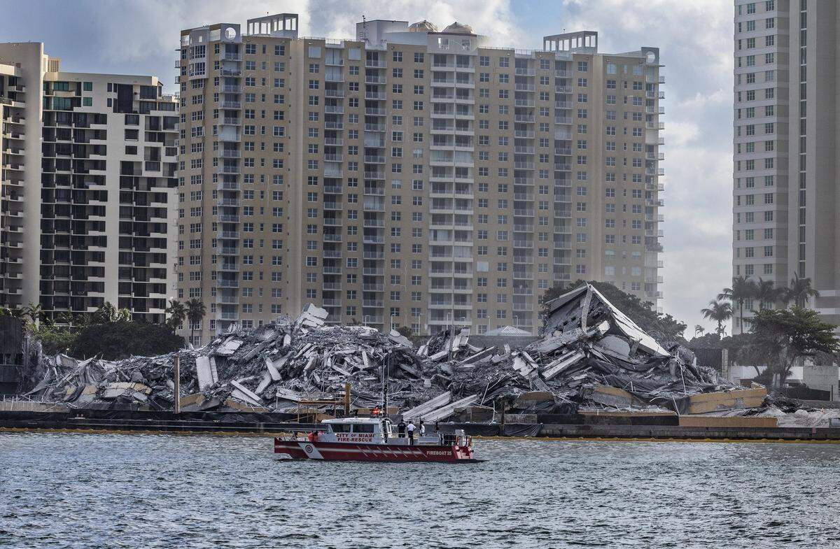 A City of Miami Fire Rescue vessel trolls for possible debris after the implosion of the former Mandarin Oriental, Miami on Brickell Key Sunday.