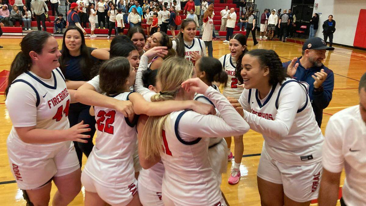 Doral Academy girls’ basketball players celebrate on the court after their win over Boca Raton in the Region 4-7A final at the Doral gym on Thursday, Feb. 22, 2024.