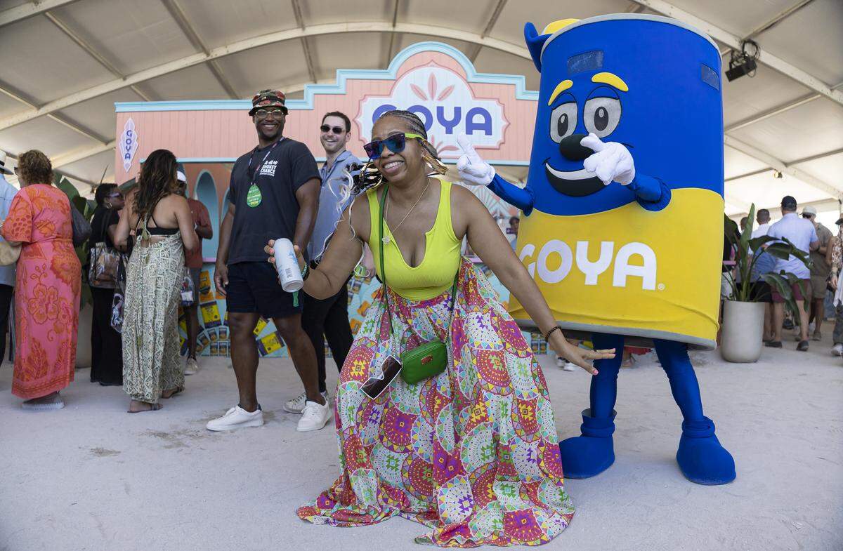 LaShawn Miller dances with a Goya mascot while attending the Goya Foods' Grand Tasting Village during the Food Network South Beach Wine & Food Festival on Saturday, Feb. 21, 2026, in Miami Beach, Fla.