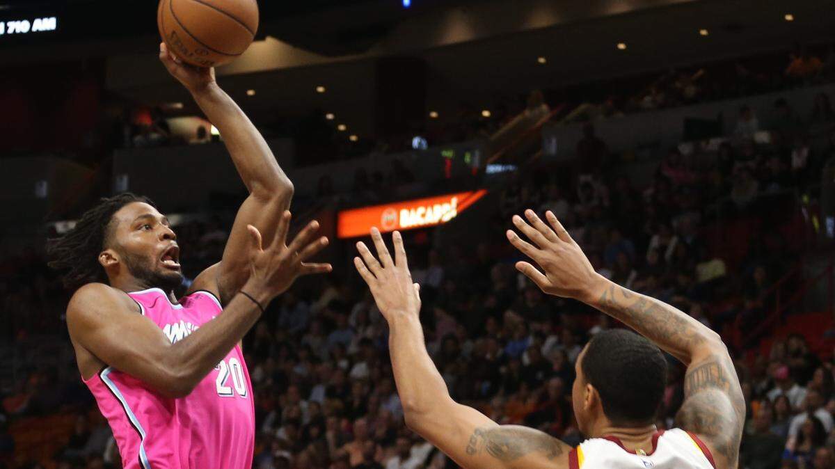 Heat forward Justise Winslow, left, takes the shot over Cavaliers forward Channing Frye, right, the first half during the NBA game between the Miami Heat and the Cleveland Cavaliers at the American Airlines Arena on Friday, December 28, 2018 in Miami, Florida.