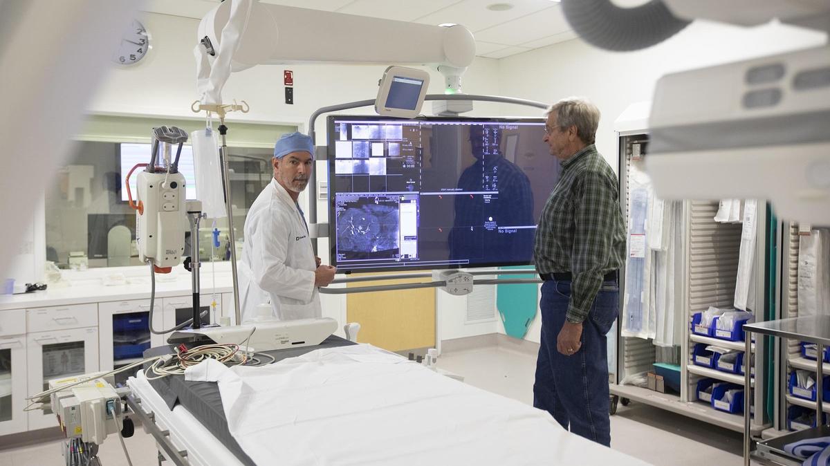 Dr. Kevin Stadtlander, section head of Interventional Radiology at Cleveland Clinic Weston, with his patient Glenn Dorries, 63, who has been battling liver cancer since 2012. He recently passed the five-year survival mark.