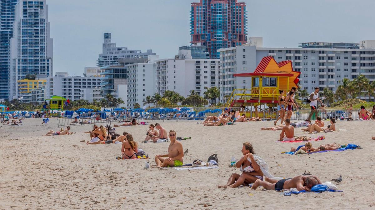 Beachgoers enjoy the nice weather during spring break in Miami Beach, Florida, on Saturday, March 22, 2025.