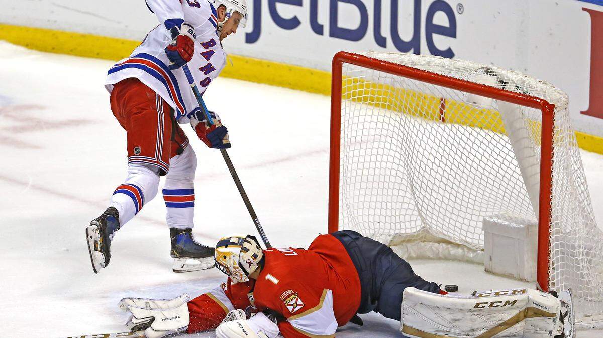New York Rangers center Kevin Hayes #13 puts a shot on net against Florida Panthers goalie Roberto Luongo #1 during the shootout of an NHL regular season hockey game at the BB&T Center on Saturday, December 8, 2018 in Sunrise.