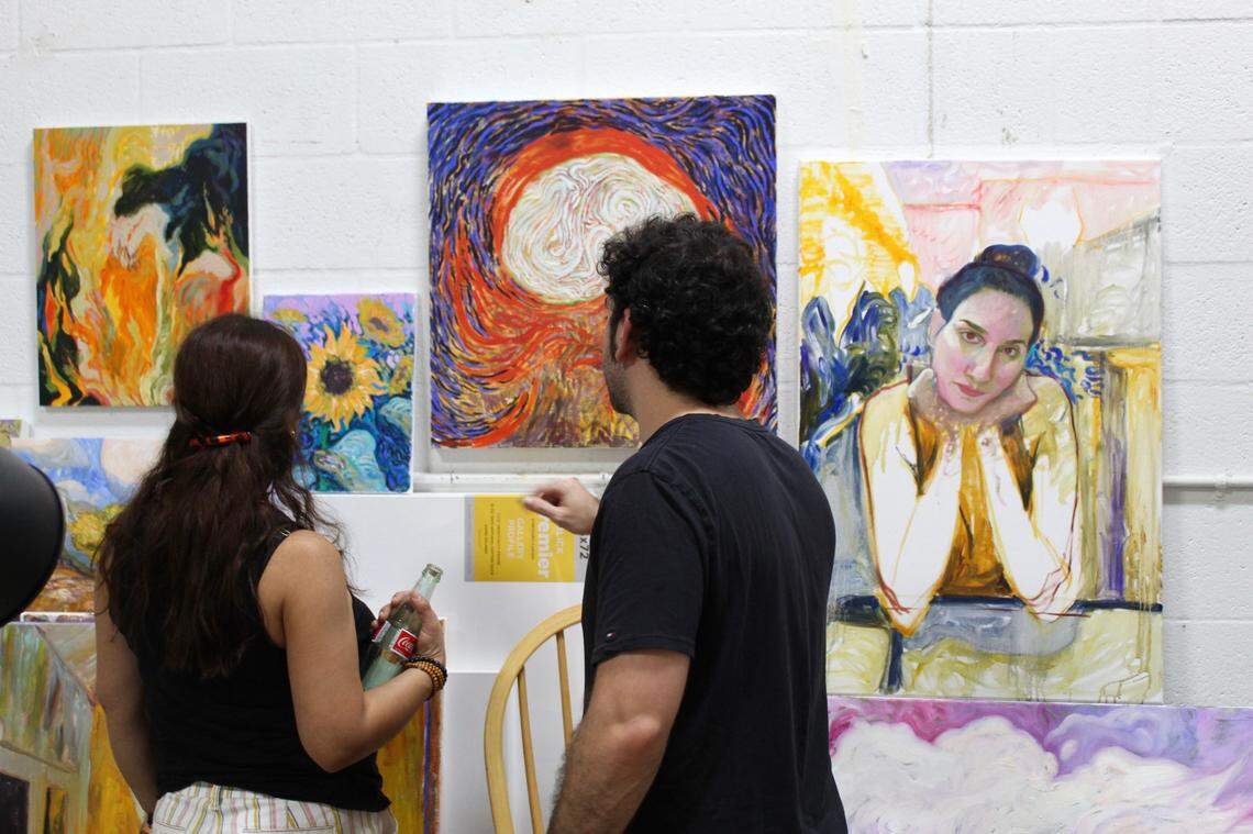 Visitors view art at CollaboARTive, a studio space near Tropical Park
