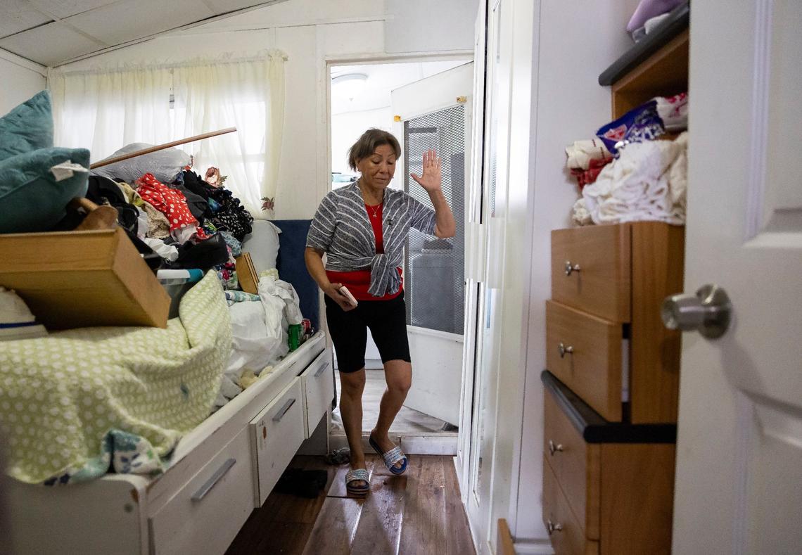 Sara Vilchez, 63, who lives at Royal Palm Mobile Home Park, reacts as she walks through her residence that was damaged by flooding on Thursday, June 13, 2024, in Hallandale Beach, Florida. Residents at the mobile home park are dealing with the aftermath of Wednesday’s storm that left their community flooded.