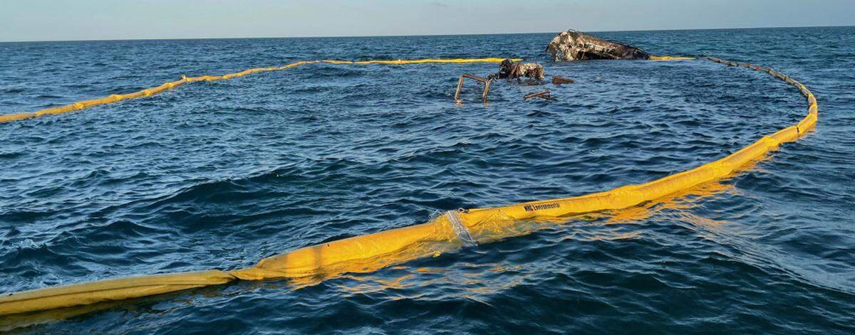 A boom surrounds the wreckage of the 100-foot yacht, La Dolce Vita, near the Marquesas on March 16, 2021. The Coast Guard is overseeing diesel spill cleanup operations.