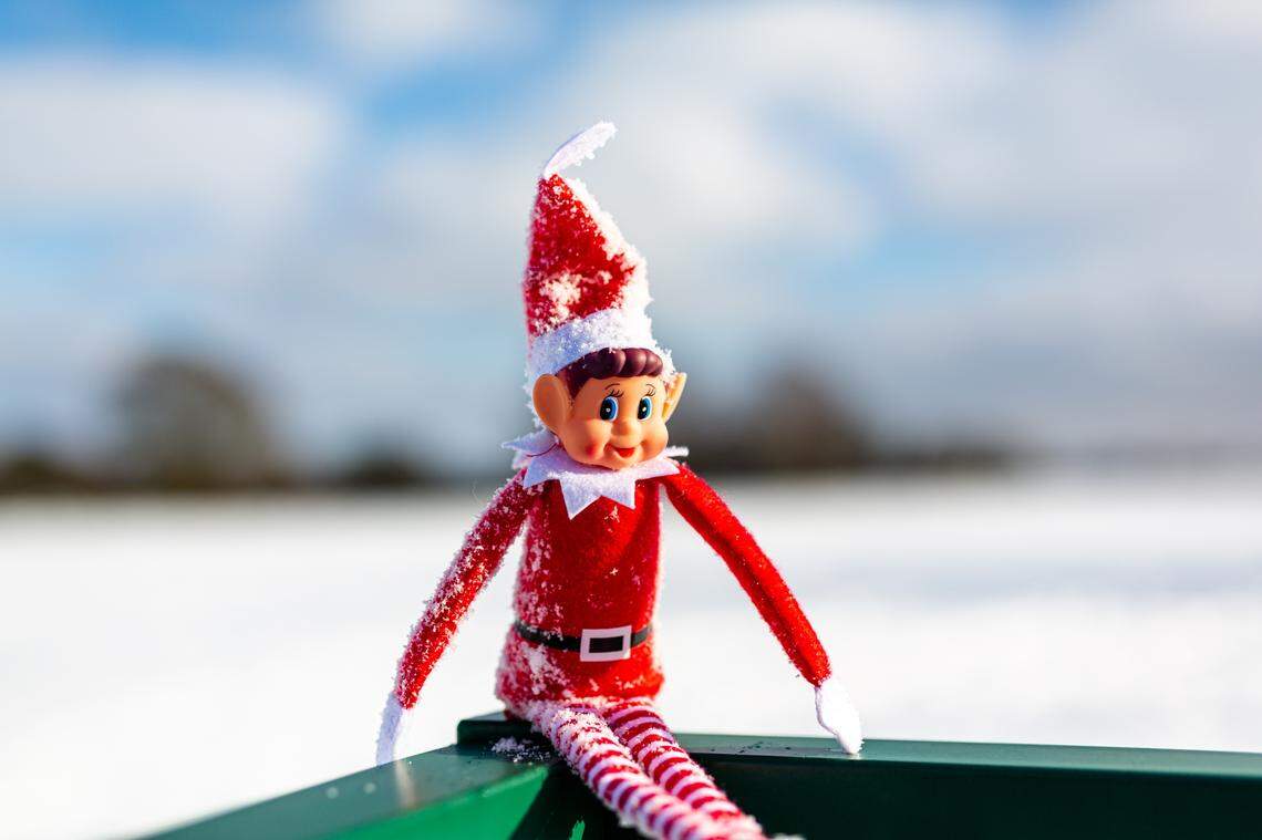 scout elf relaxing outside in the snow