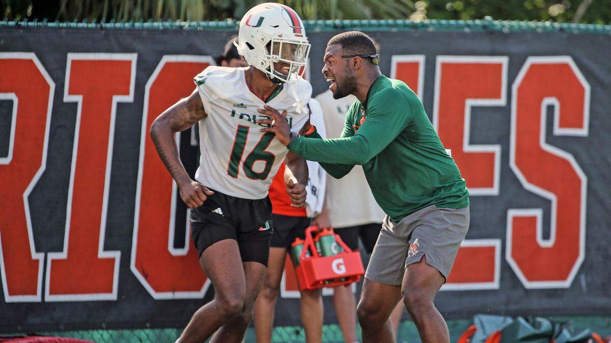 Miami Hurricanes defensive backs coach Jahmile Addae works with Malik Curtis (16) during practice at the University of Miami’s Greentree Field on Tuesday, March 7, 2023.