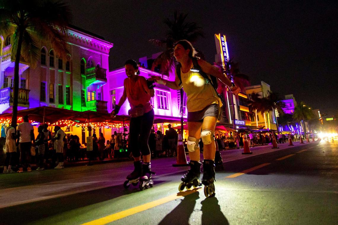 Two roller skaters wheel up Ocean Drive during the second day of Memorial Day Weekend in Miami Beach, Florida, on Saturday, May 28, 2022.