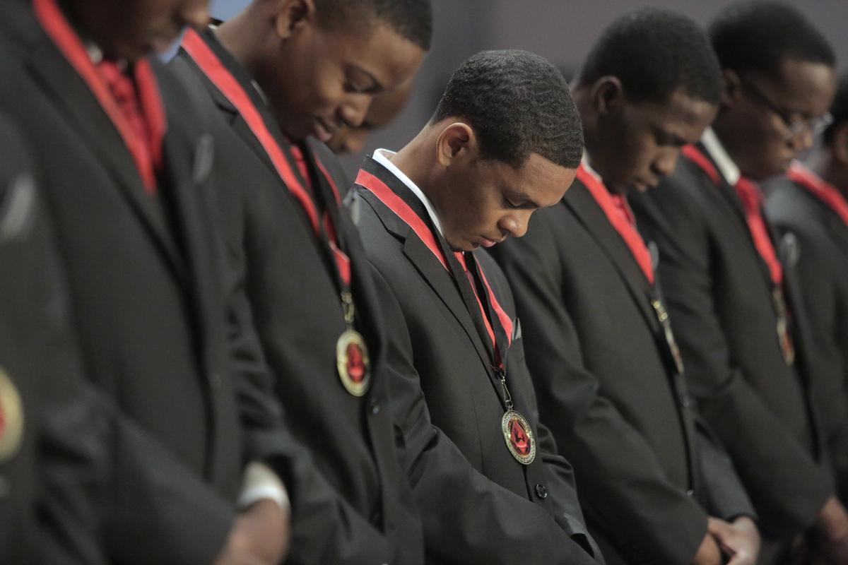 Albert Hernandez III, center, bows his head along with fellow scholarship winners during a benediction as part of the program during the 5000 Role Models of Excellence Project’s 26th Annual Dr. Martin Luther King Jr. Scholarship Breakfast on Monday, Jan. 21, 2019.