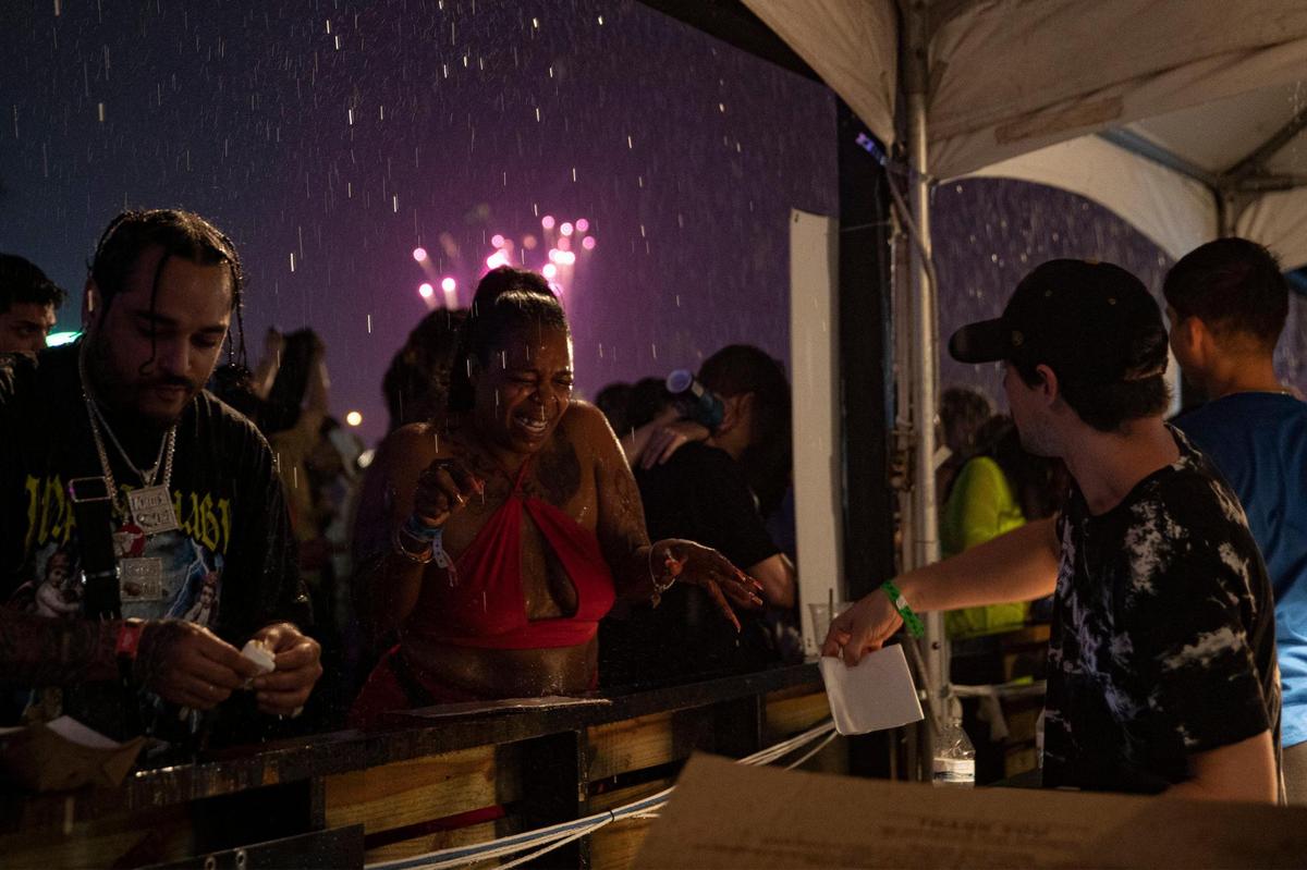 People get caught in the rain at Rolling Loud at Hard Rock Stadium in Miami Gardens, Florida on Sunday, July 24, 2022.