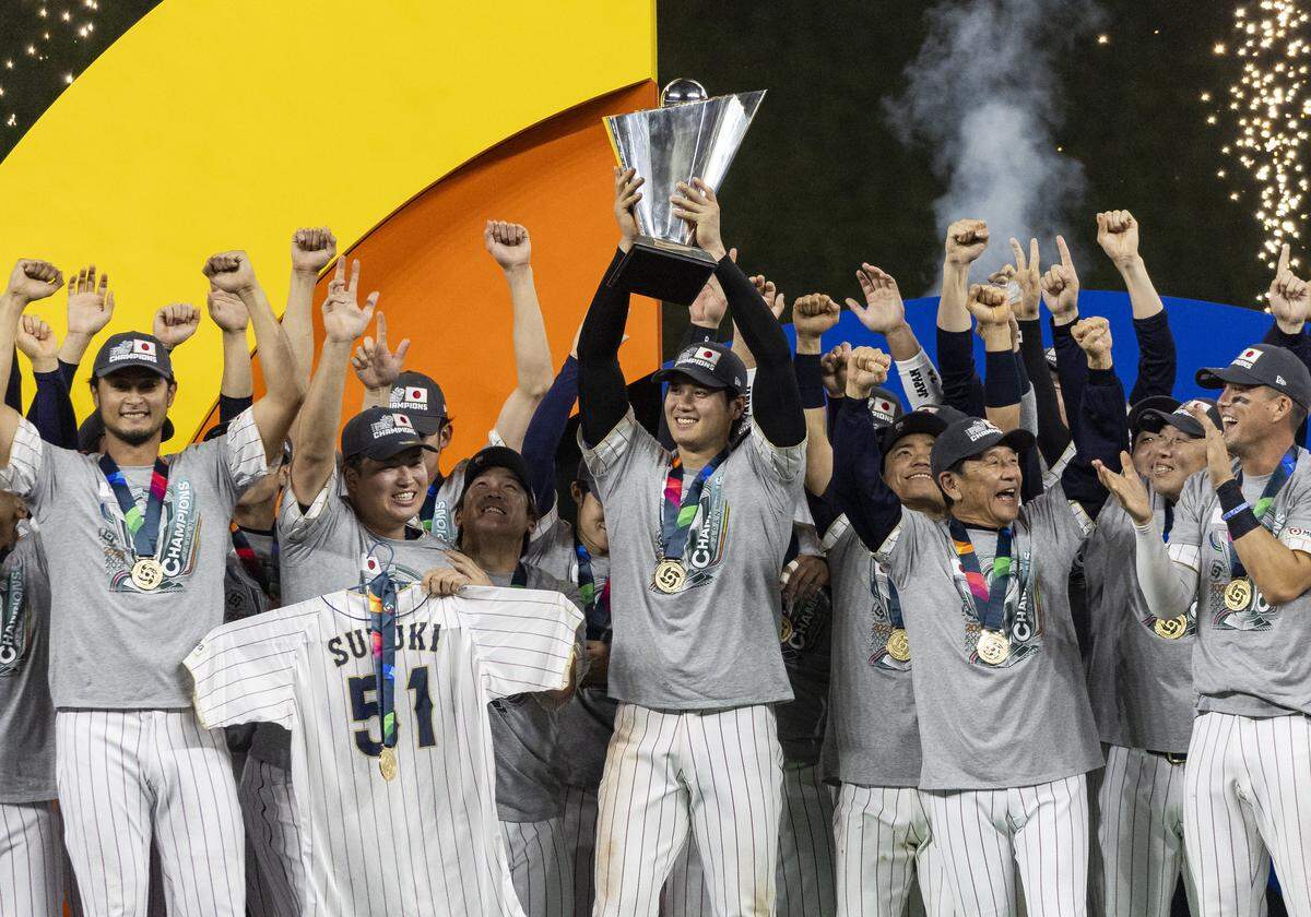 Japan pitcher Shohei Ohtani (16) celebrates with his teammates during an award ceremony after defeating the United States in the championship game at the World Baseball Classic at loanDepot Park on Tuesday, March 21, 2023, in Miami, Fla.