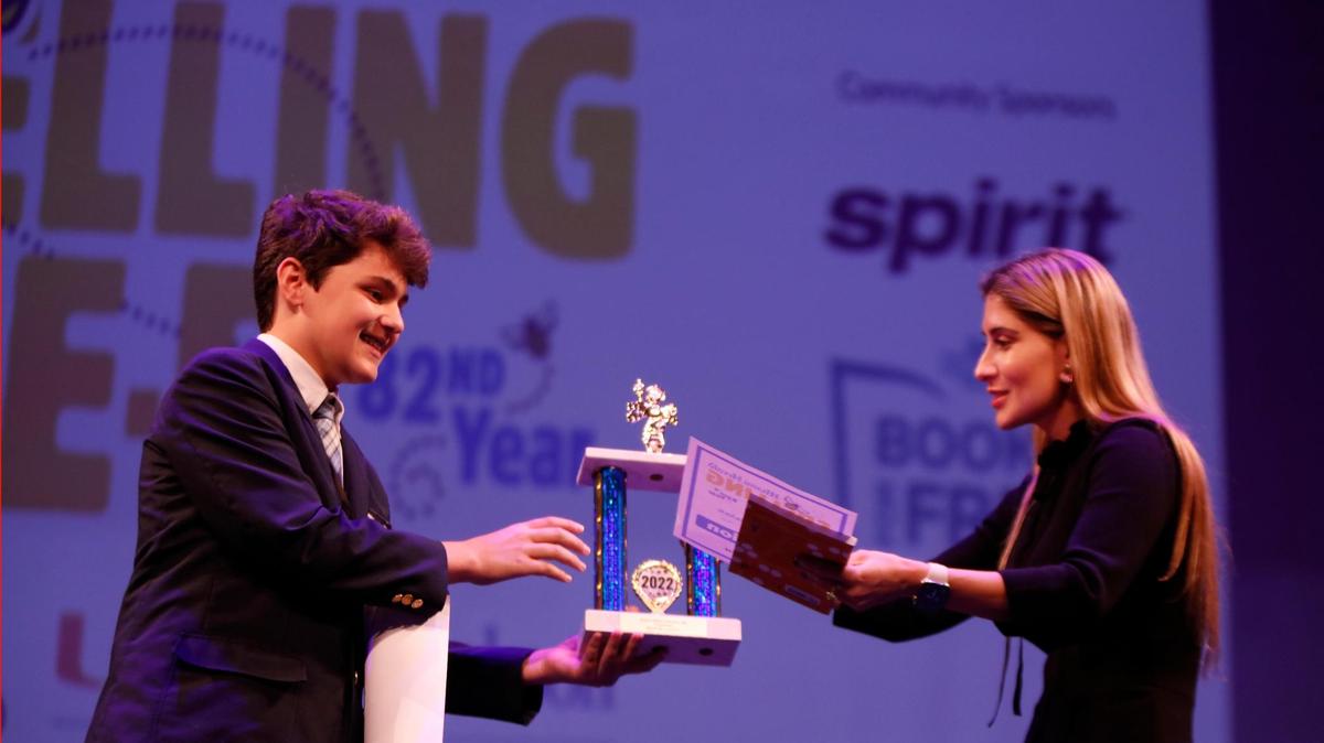 The Miami Herald Spelling Bee Winner Brody Santos, 12, a seventh-grader from St. Mark’s Episcopal School in Fort Lauderdale, is presented his first-place trophy Thursday, March 17, by Juliana Echavarria, operations and special projects manager of the Miami Herald, el Nuevo Herald and the Bradenton Herald. The Bee, in its 82nd year, was held at the Charles F. Dodge City Center, Pembroke Pines.
