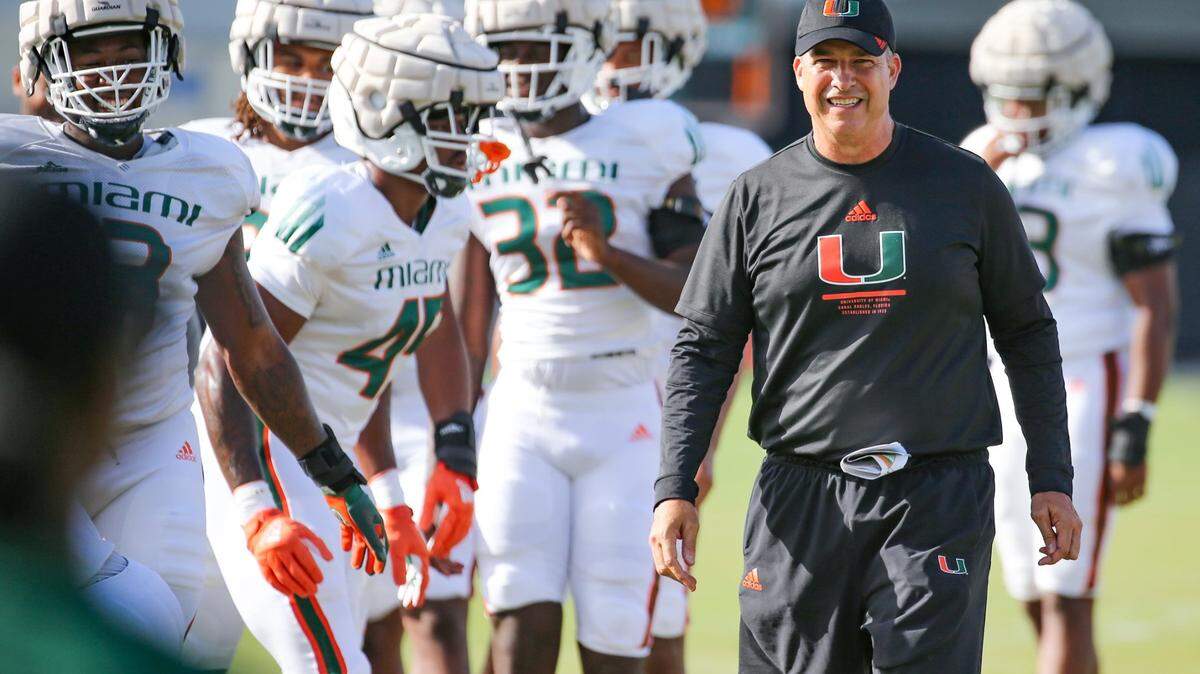 Miami Hurricanes Mario Cristobal watches over his players during practice drills at Greentree Practice Field at the University of Miami in Coral Gables on Thursday, August 11, 2022.