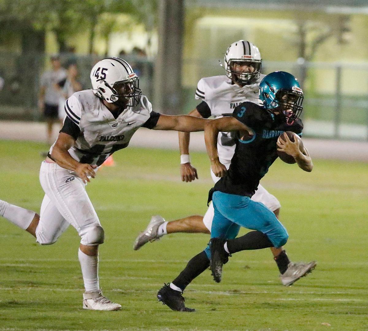 Coral Reef Barracudas wide receiver Nathan Miranda (3) tries to break free from Ferguson Falcons defenders during the GMAC Independent Conference title football game on Thursday, November 14, 2024 at Southridge HS in Miami. Andrew Uloza / for Miami Herald
